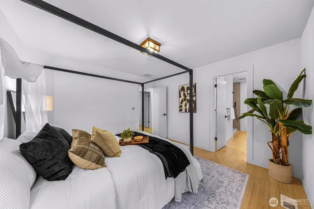 a bedroom with a bed and a chandelier