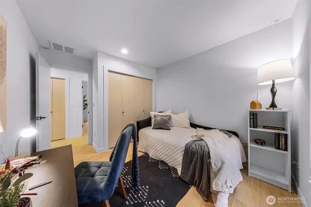 a bedroom with a bed and a lamp