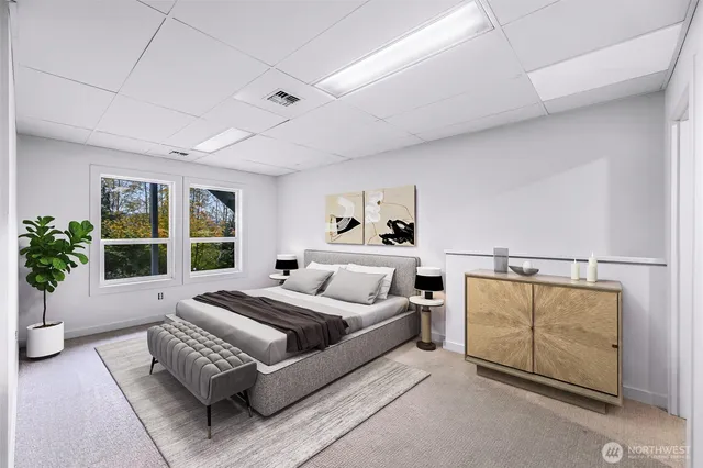 a room with furniture a rug and white walls