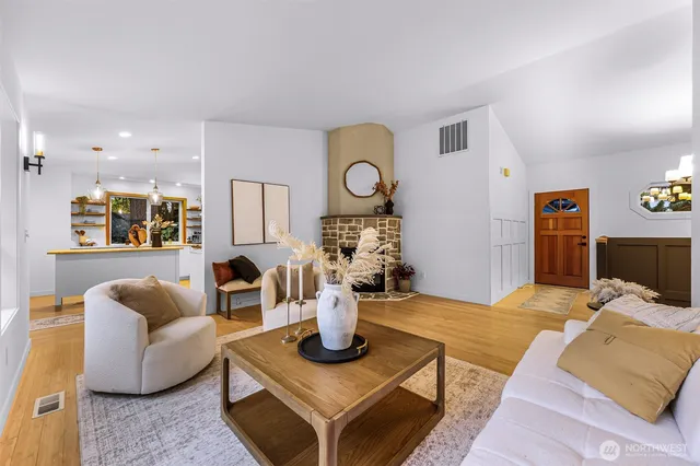 a living room with furniture a rug and a fireplace