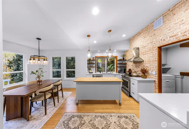 a large kitchen with a table and chairs in it