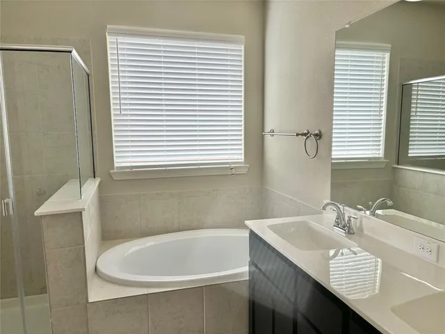 a white bath tub sitting next to a white sink