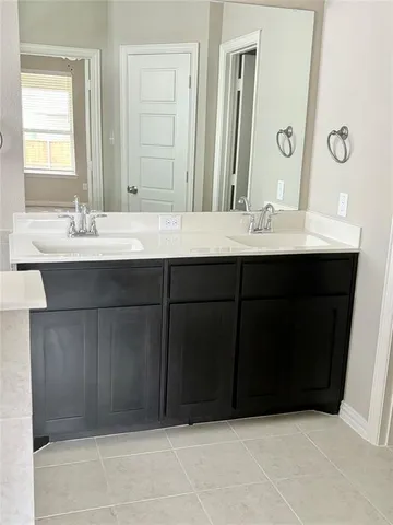 a bathroom with a sink vanity and mirror