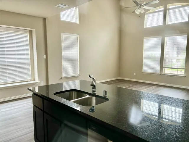 a kitchen with a sink and large window