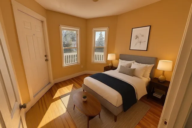 a bedroom with a bed and wooden floor