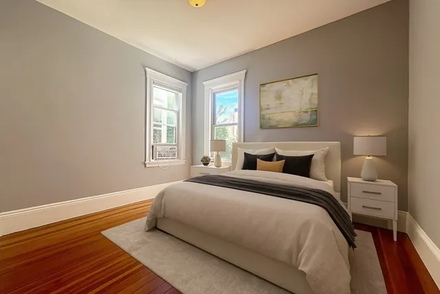 a bedroom with bed and wooden floor