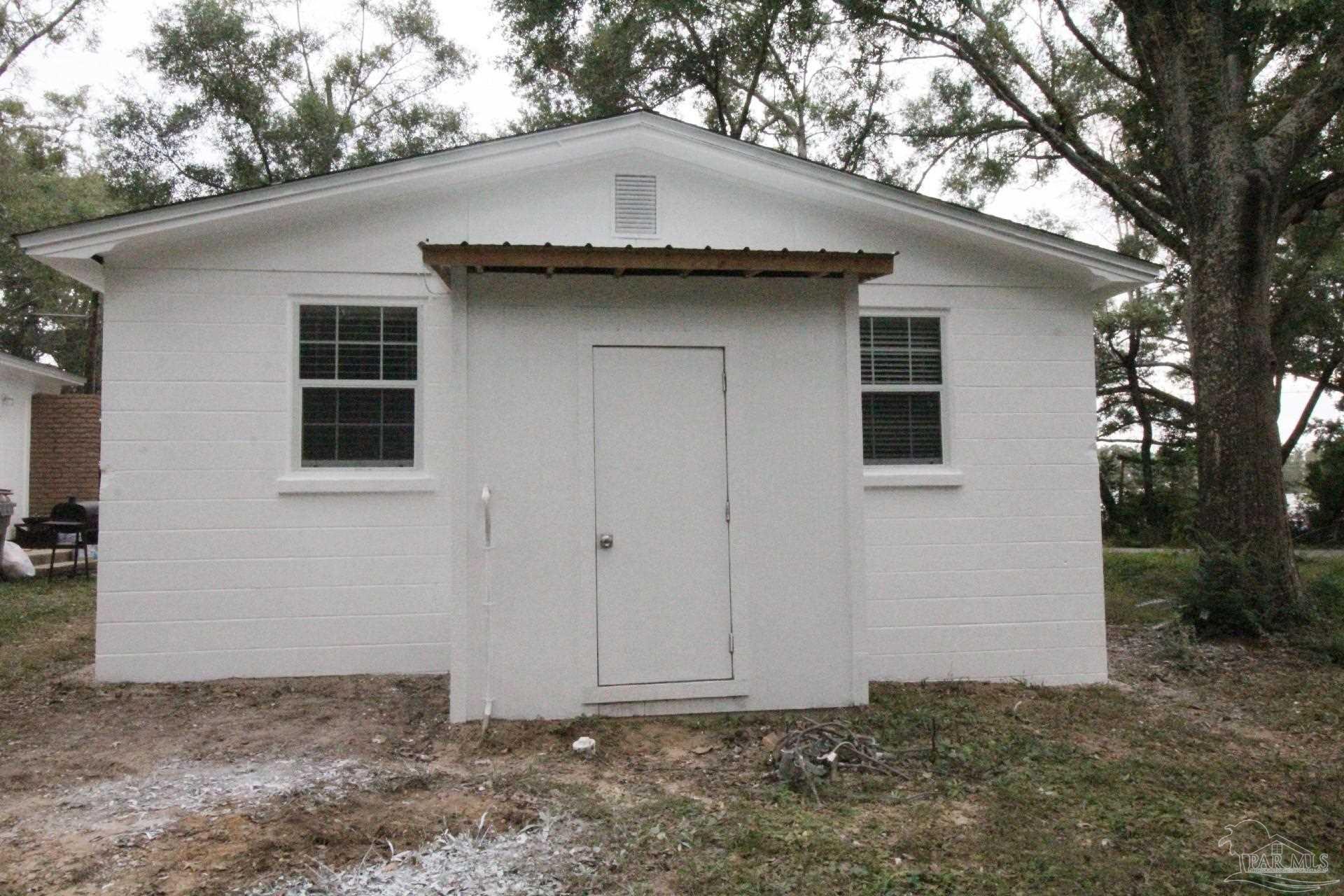 5523 Shell Street Pensacola, FL 32503 - Photo 11 of 11 a front view of a house with a garden