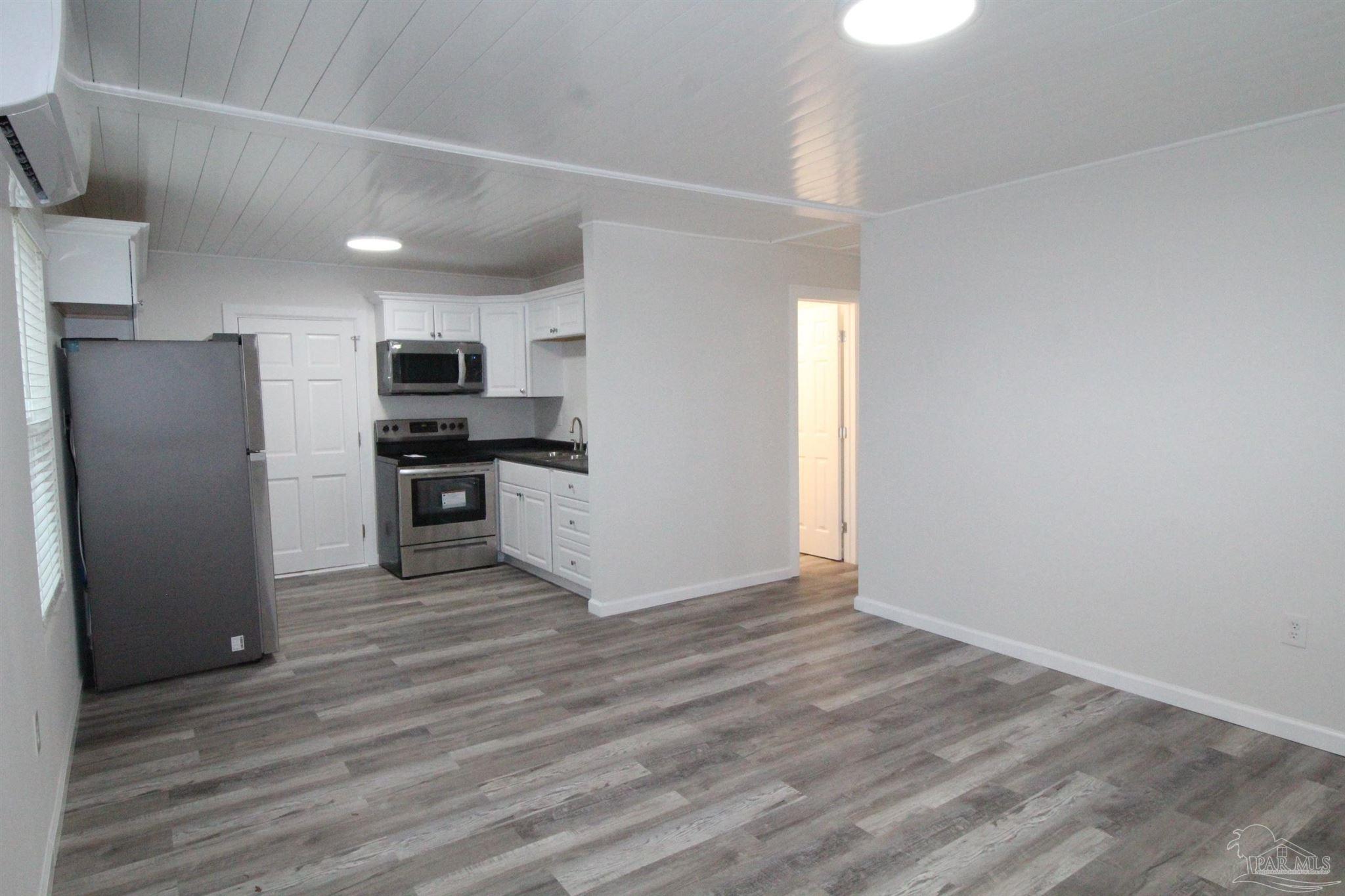 5523 Shell Street Pensacola, FL 32503 - Photo 2 of 11 a view of kitchen view wooden cabinets and stainless steel appliances