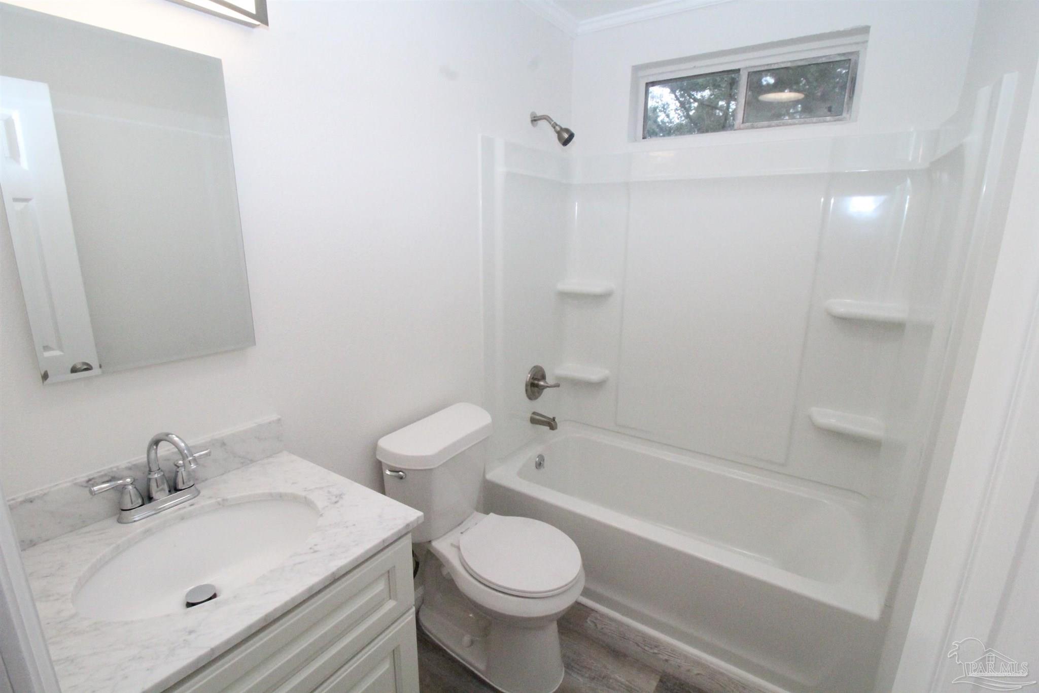 5523 Shell Street Pensacola, FL 32503 - Photo 7 of 11 a bathroom with a sink toilet and bathtub