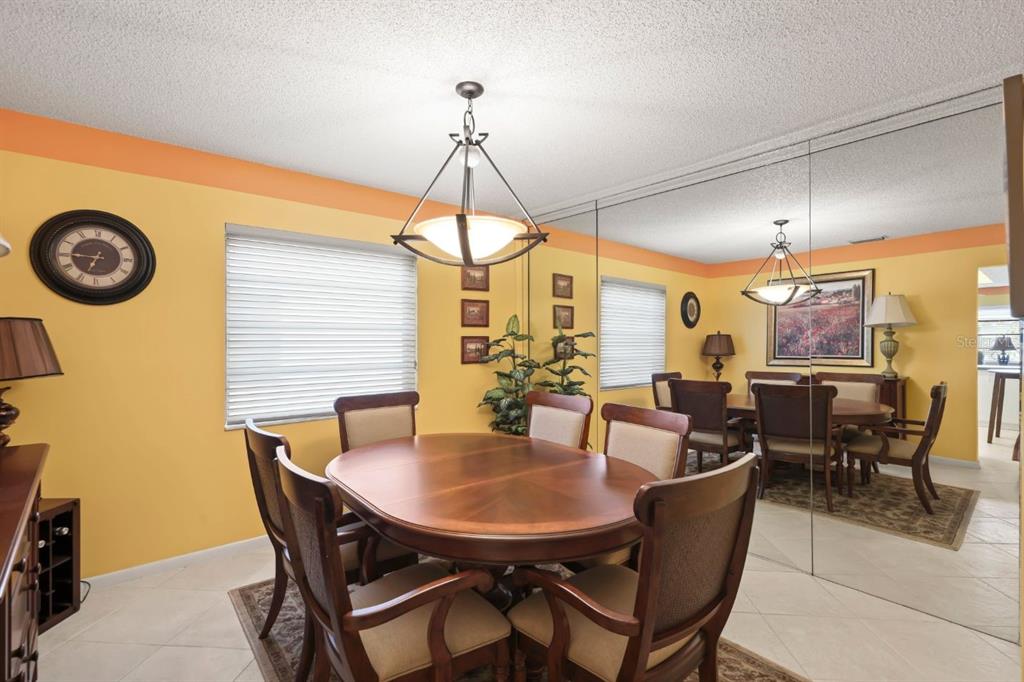 10618 180th Place South Boca Raton, FL 33498 - Photo 12 of 45 a view of a dining room with furniture and a chandelier