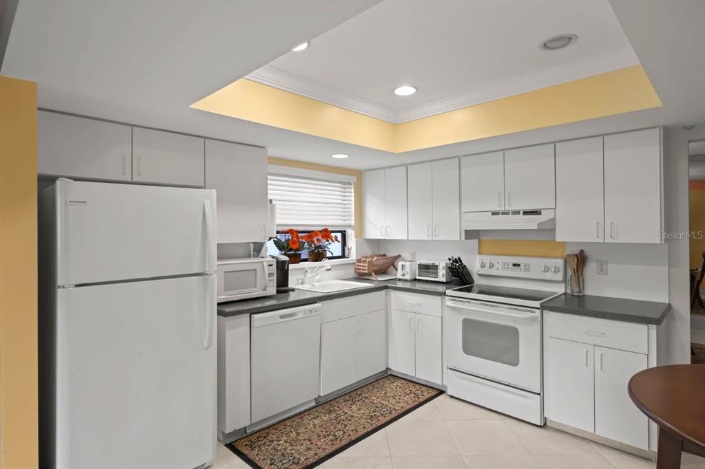 10618 180th Place South Boca Raton, FL 33498 - Photo 15 of 45 a kitchen with white cabinets sink and white appliances