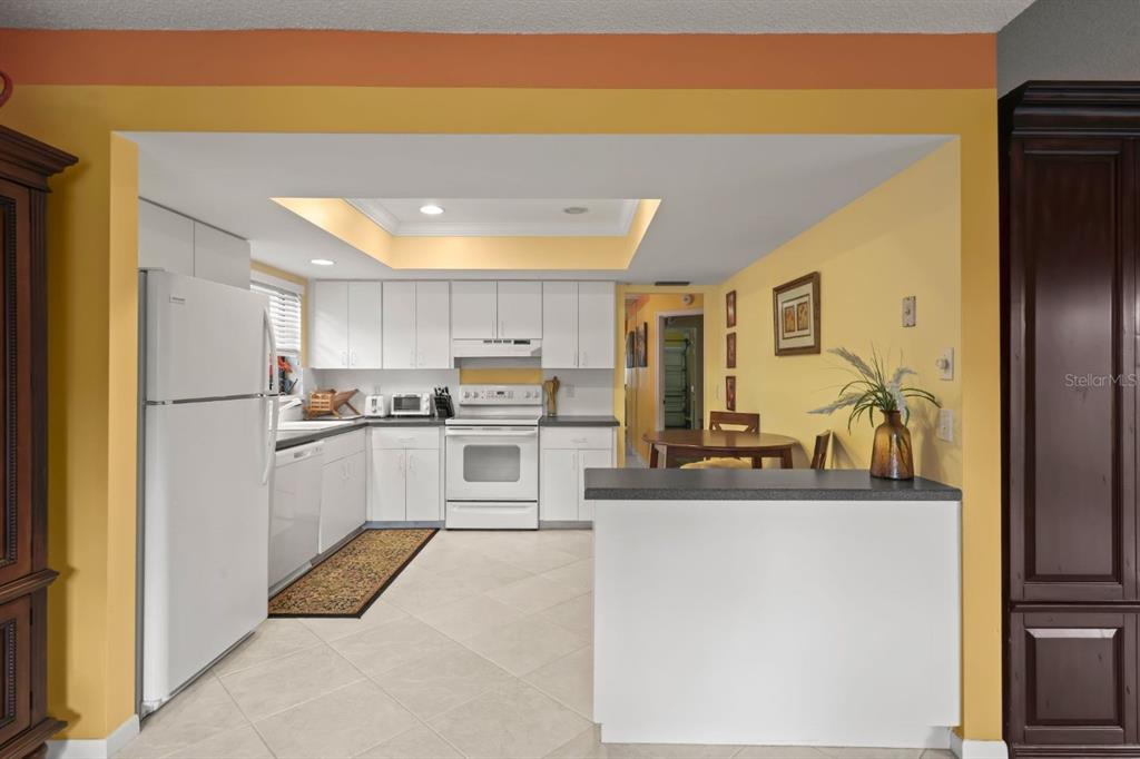10618 180th Place South Boca Raton, FL 33498 - Photo 16 of 45 a kitchen with white cabinets and refrigerator