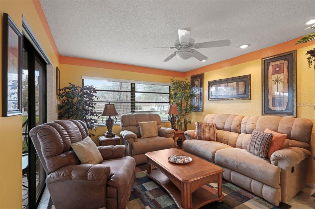 10618 180th Place South Boca Raton, FL 33498 - Photo 18 of 45 a living room with furniture a ceiling fan and a large window