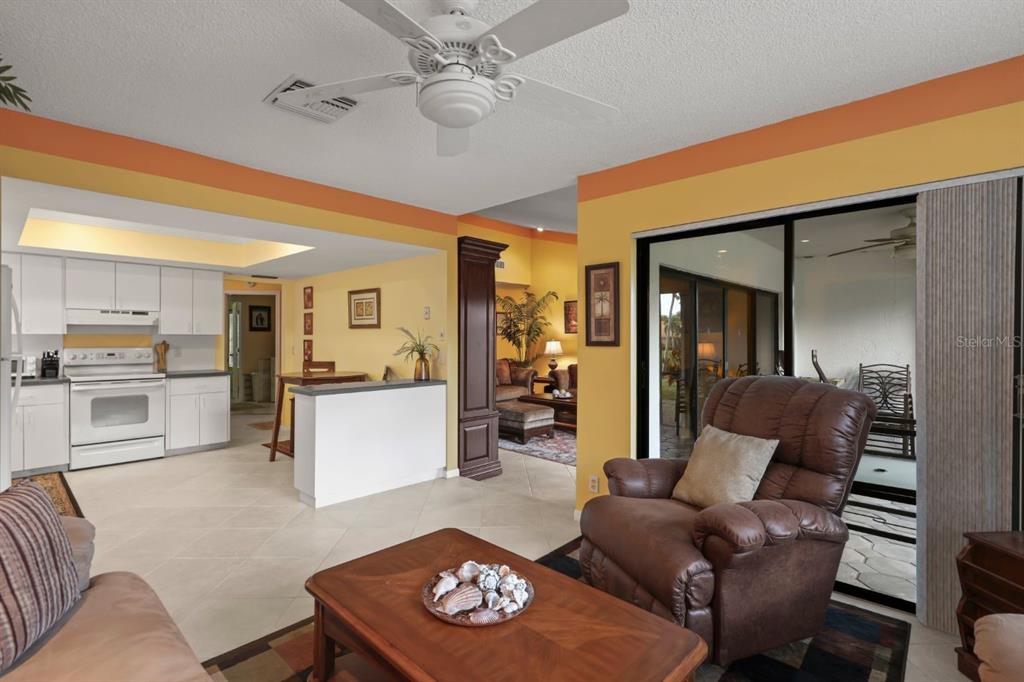 10618 180th Place South Boca Raton, FL 33498 - Photo 19 of 45 a living room with furniture and a dining table with kitchen view