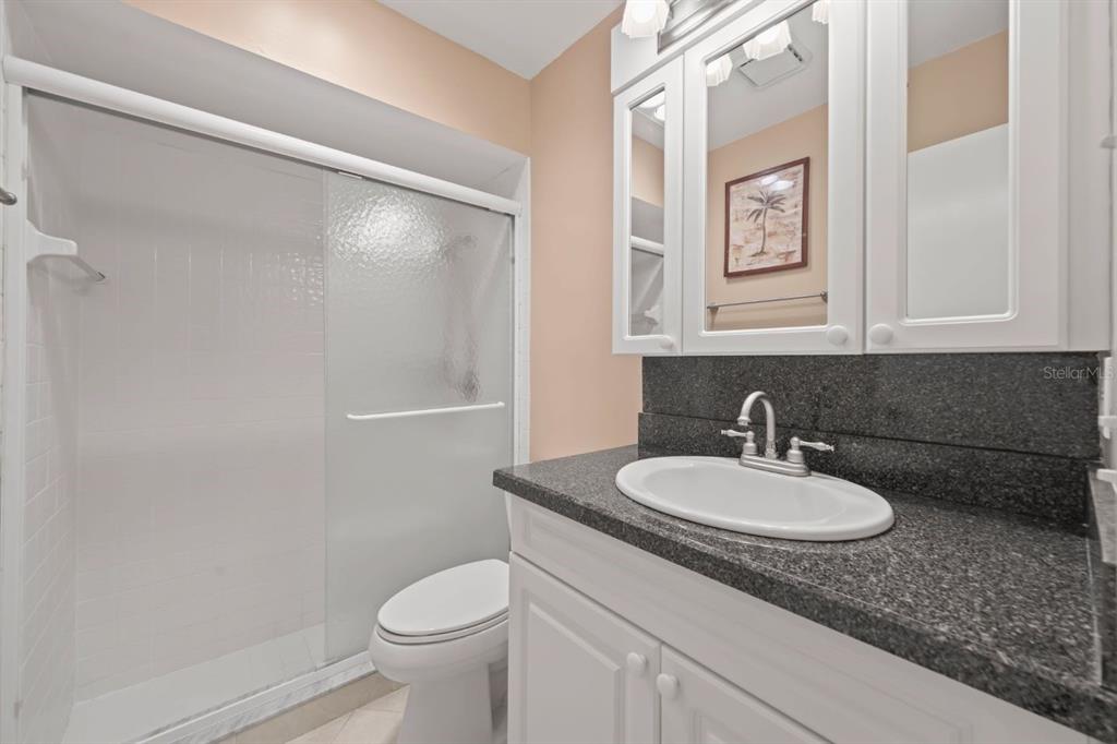 10618 180th Place South Boca Raton, FL 33498 - Photo 21 of 45 a bathroom with a granite countertop sink toilet and a mirror
