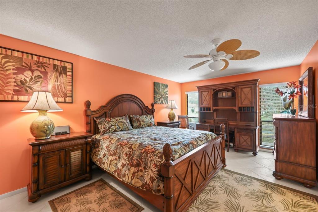 10618 180th Place South Boca Raton, FL 33498 - Photo 24 of 45 a bedroom with a bed and a flat tv screen on wall
