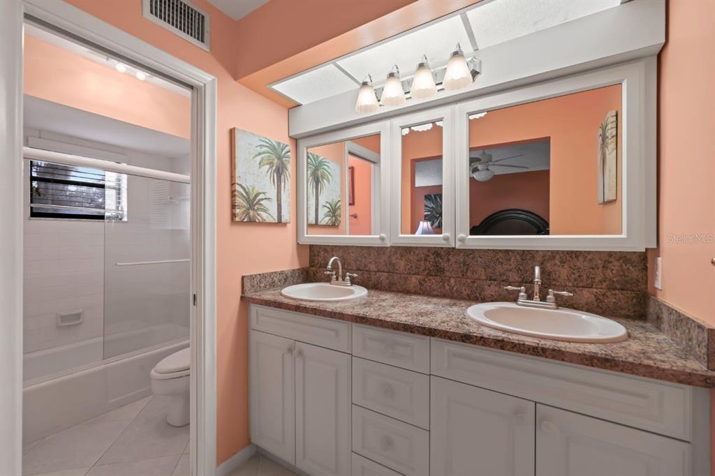 10618 180th Place South Boca Raton, FL 33498 - Photo 27 of 45 a bathroom with a granite countertop sink mirror and bathtub