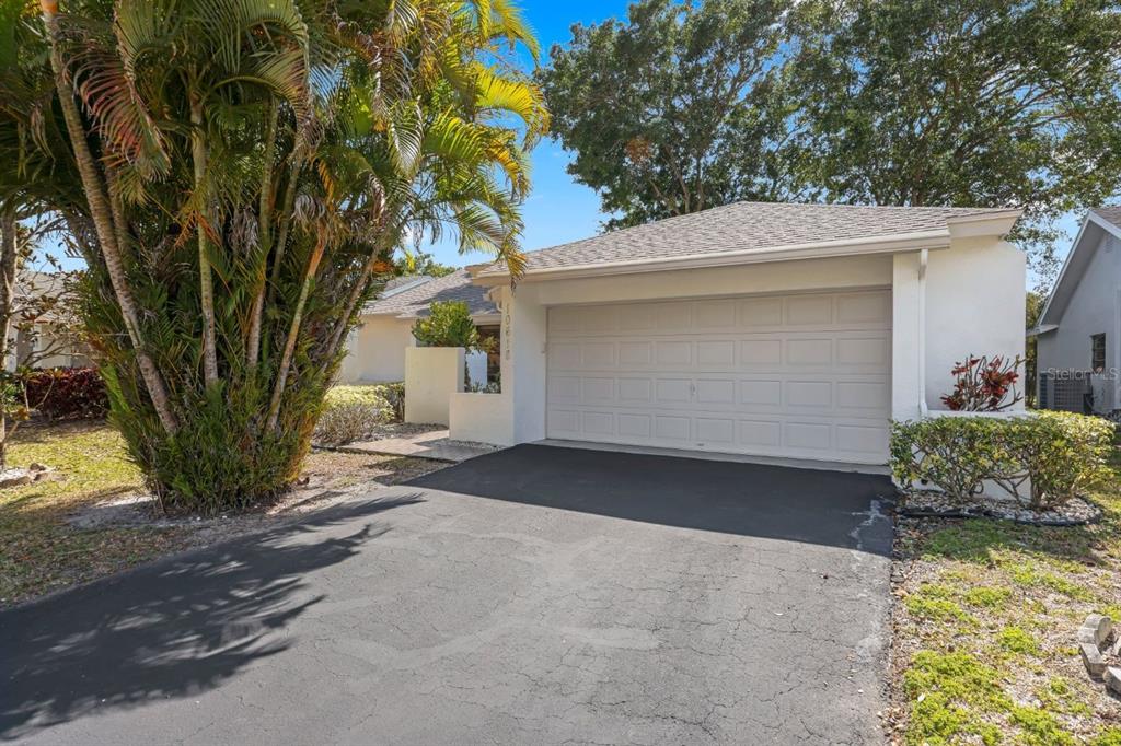 10618 180th Place South Boca Raton, FL 33498 - Photo 3 of 45 a front view of a house with a yard and garage
