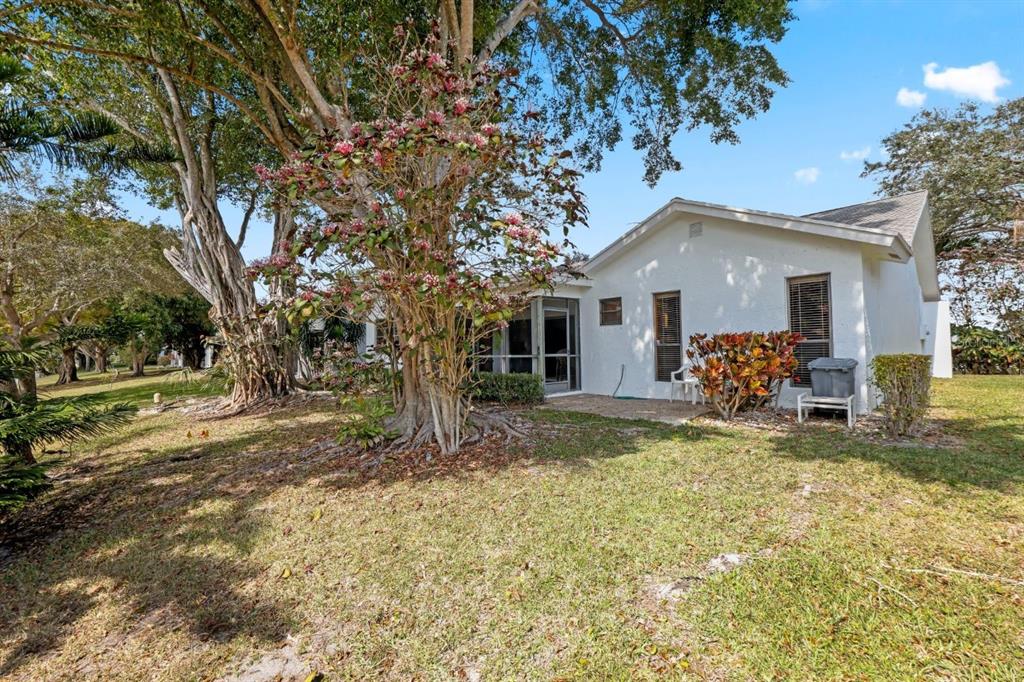 10618 180th Place South Boca Raton, FL 33498 - Photo 36 of 45 a view of a house with a patio and a yard