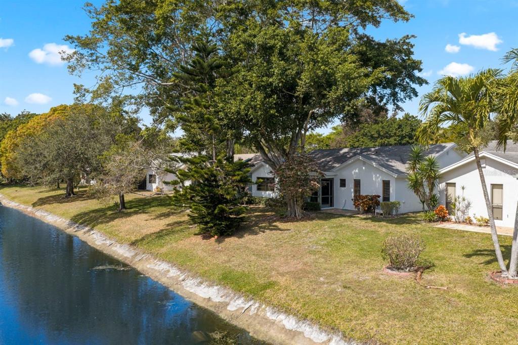 10618 180th Place South Boca Raton, FL 33498 - Photo 40 of 45 a view of a yard with plants and a tree