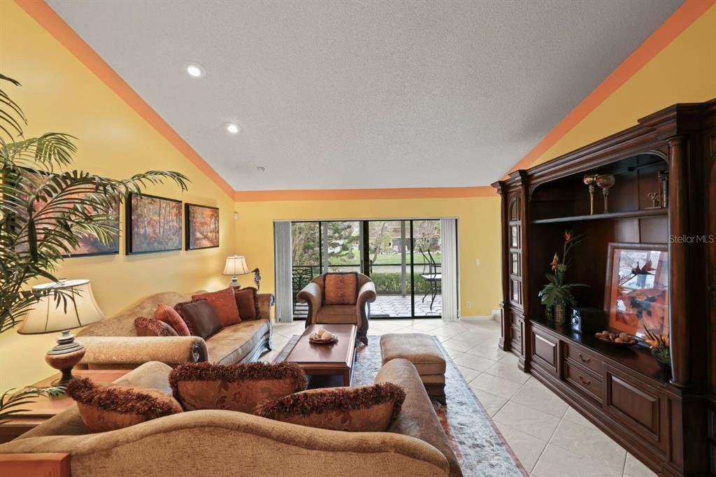 10618 180th Place South Boca Raton, FL 33498 - Photo 7 of 45 a living room with furniture a flat screen tv and a floor to ceiling window