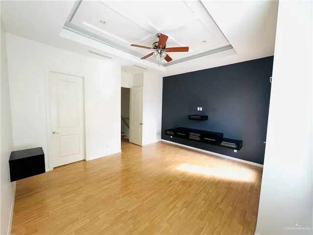an empty room with closet and windows