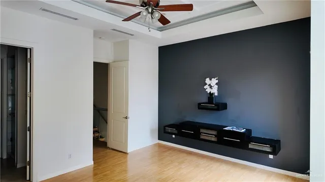 a room with pool table and wooden floor