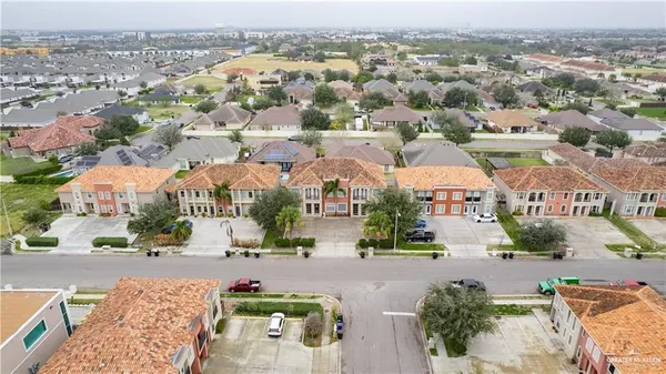 an aerial view of residential houses with city view