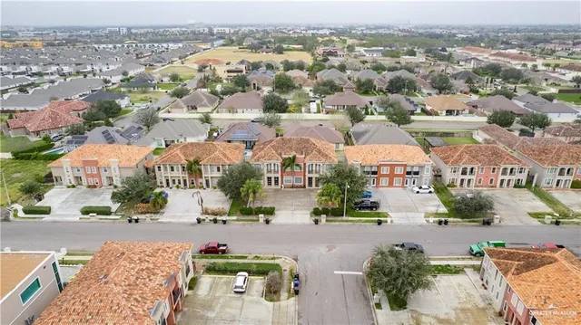 an aerial view of residential houses with city view