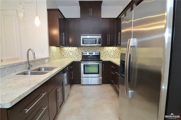 a view of a chandelier fan and entryway