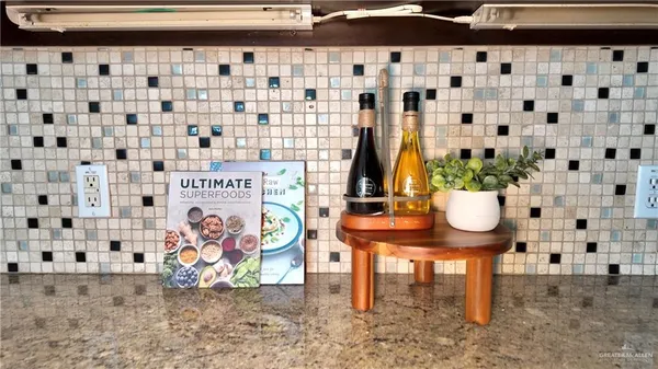 a kitchen with kitchen island a counter appliances a sink and cabinets
