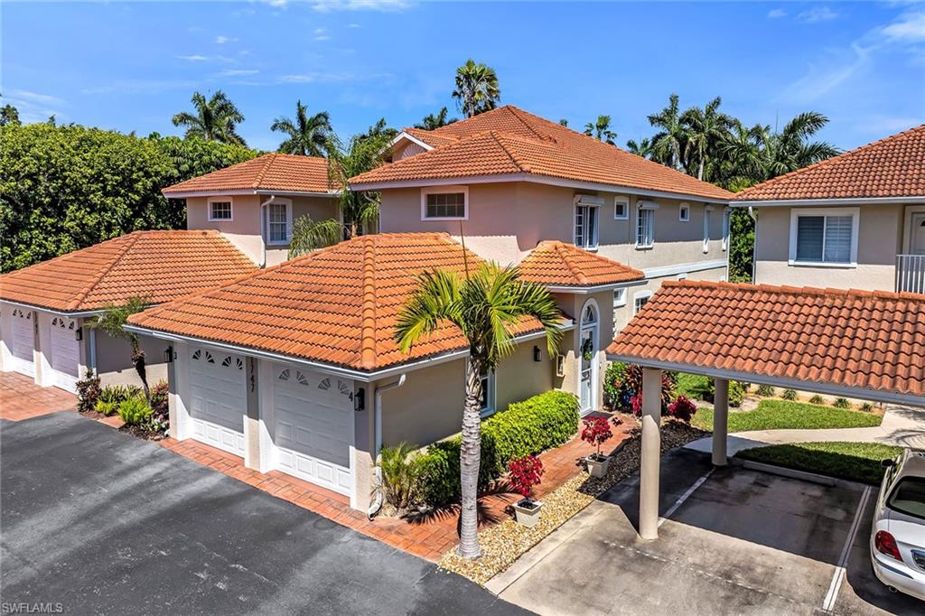 1747 Reuven Circle, Unit 4 Naples, FL 34112 - Photo 1 of 46 a front view of a house with a yard