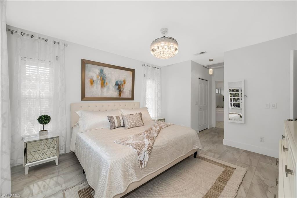 1747 Reuven Circle, Unit 4 Naples, FL 34112 - Photo 16 of 46 a bedroom with a bed and a window