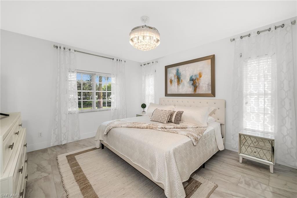1747 Reuven Circle, Unit 4 Naples, FL 34112 - Photo 17 of 46 a bedroom with a bed and a window