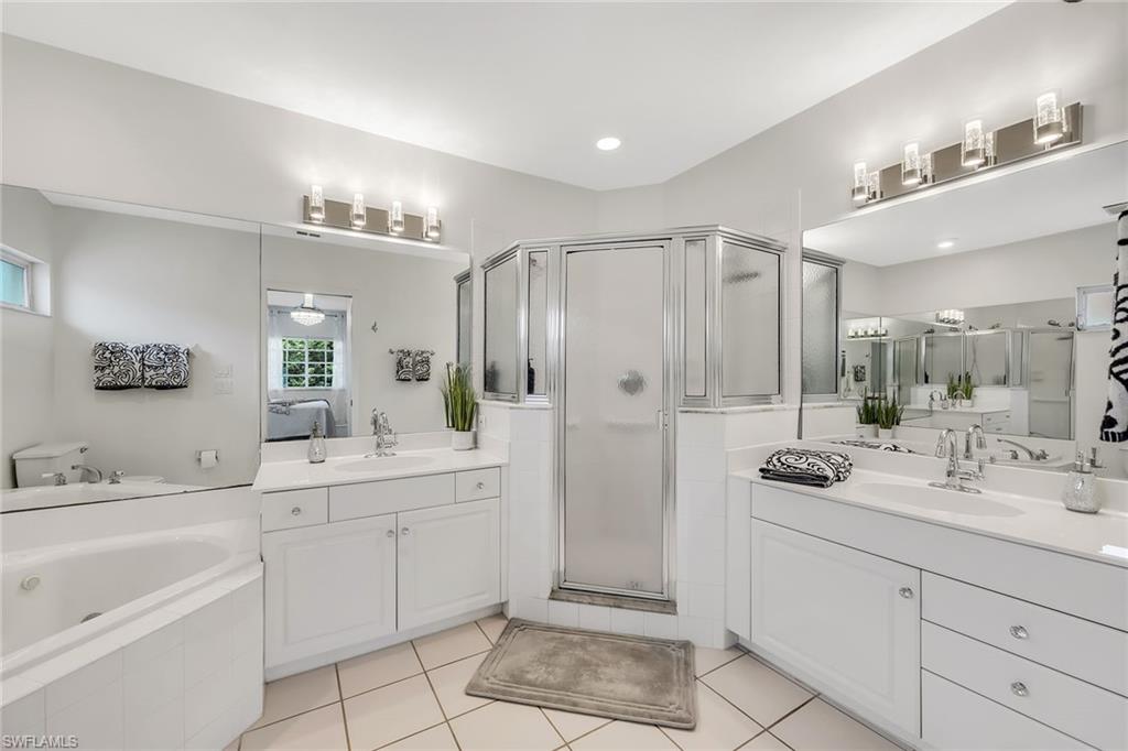 1747 Reuven Circle, Unit 4 Naples, FL 34112 - Photo 20 of 46 a bathroom with a double vanity sink mirror and shower
