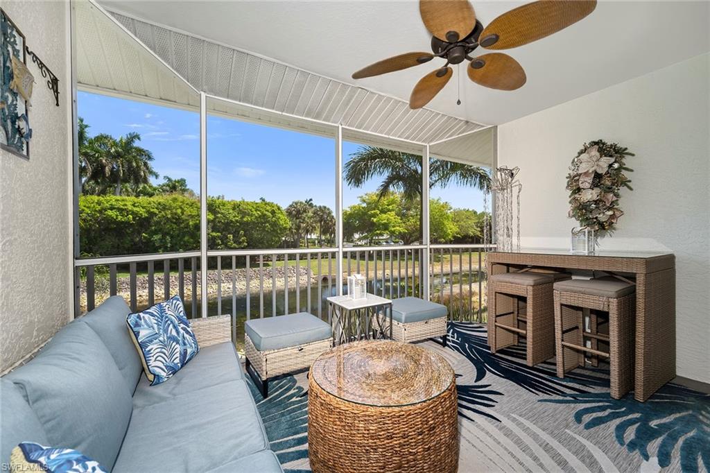 1747 Reuven Circle, Unit 4 Naples, FL 34112 - Photo 2 of 46 a living room with furniture a fireplace and a chandelier
