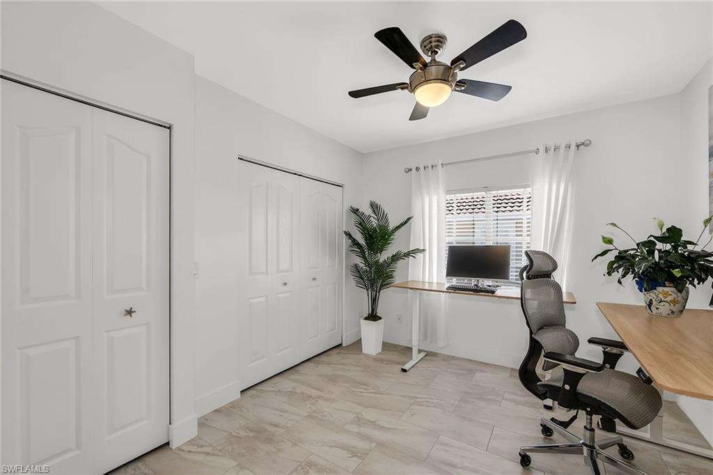 1747 Reuven Circle, Unit 4 Naples, FL 34112 - Photo 24 of 46 a workspace with furniture and a potted plant