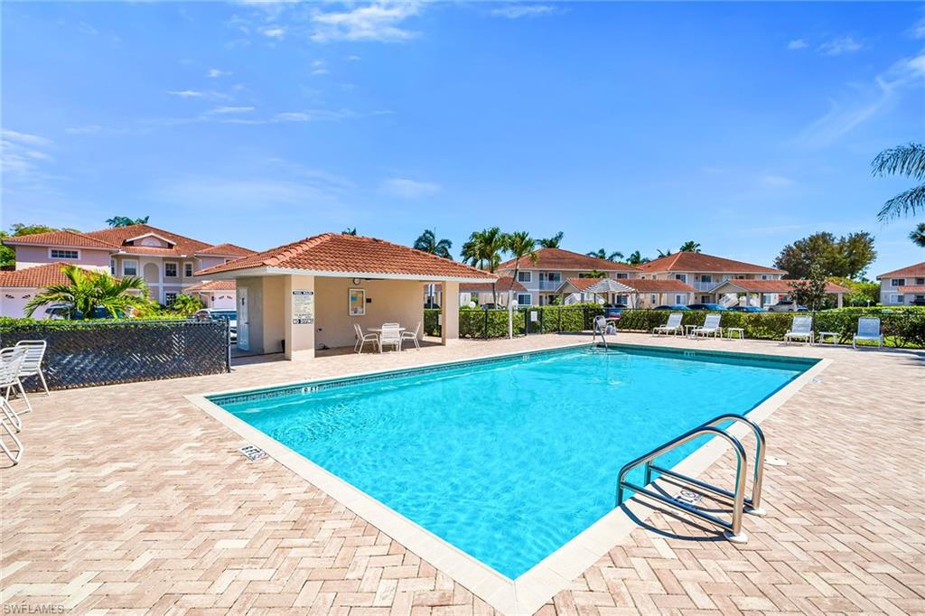 1747 Reuven Circle, Unit 4 Naples, FL 34112 - Photo 29 of 46 a view of swimming pool with a lounge chair