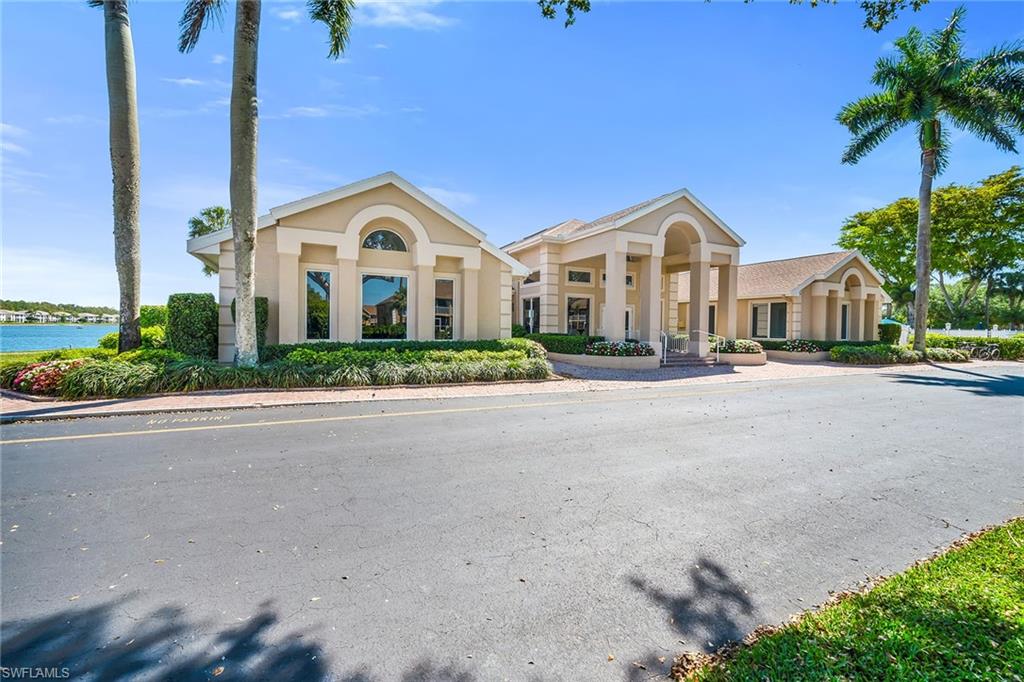 1747 Reuven Circle, Unit 4 Naples, FL 34112 - Photo 31 of 46 a front view of a house with a garden and plants
