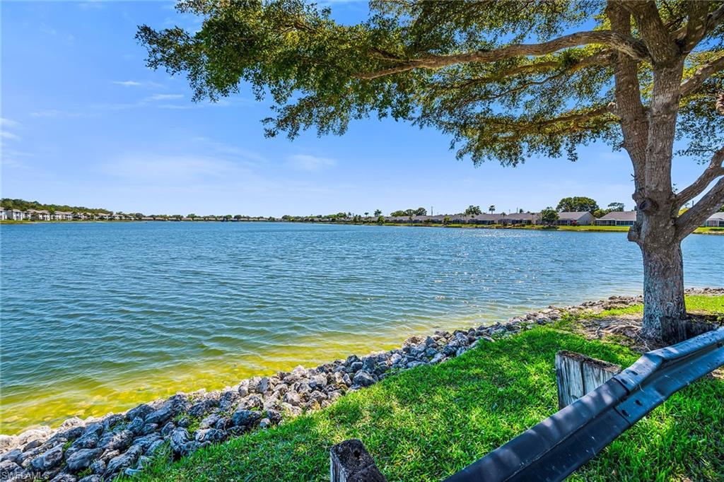 1747 Reuven Circle, Unit 4 Naples, FL 34112 - Photo 32 of 46 a view of a lake with a big yard
