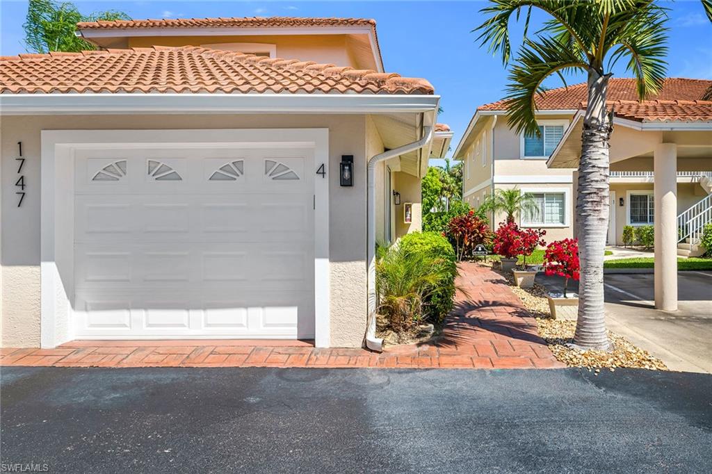 1747 Reuven Circle, Unit 4 Naples, FL 34112 - Photo 33 of 46 a front view of a house with a porch