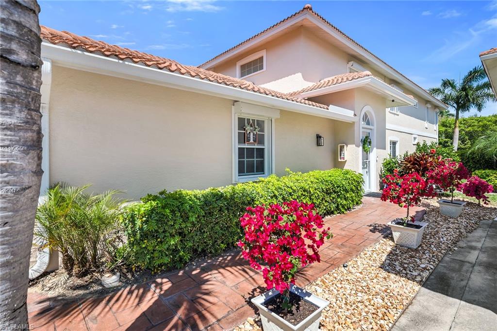 1747 Reuven Circle, Unit 4 Naples, FL 34112 - Photo 35 of 46 a front view of a house with a yard