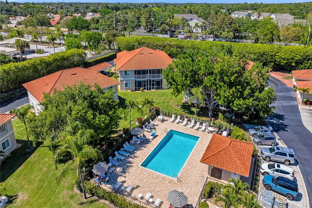 1747 Reuven Circle, Unit 4 Naples, FL 34112 - Photo 40 of 46 an aerial view of a house with a garden and lake view