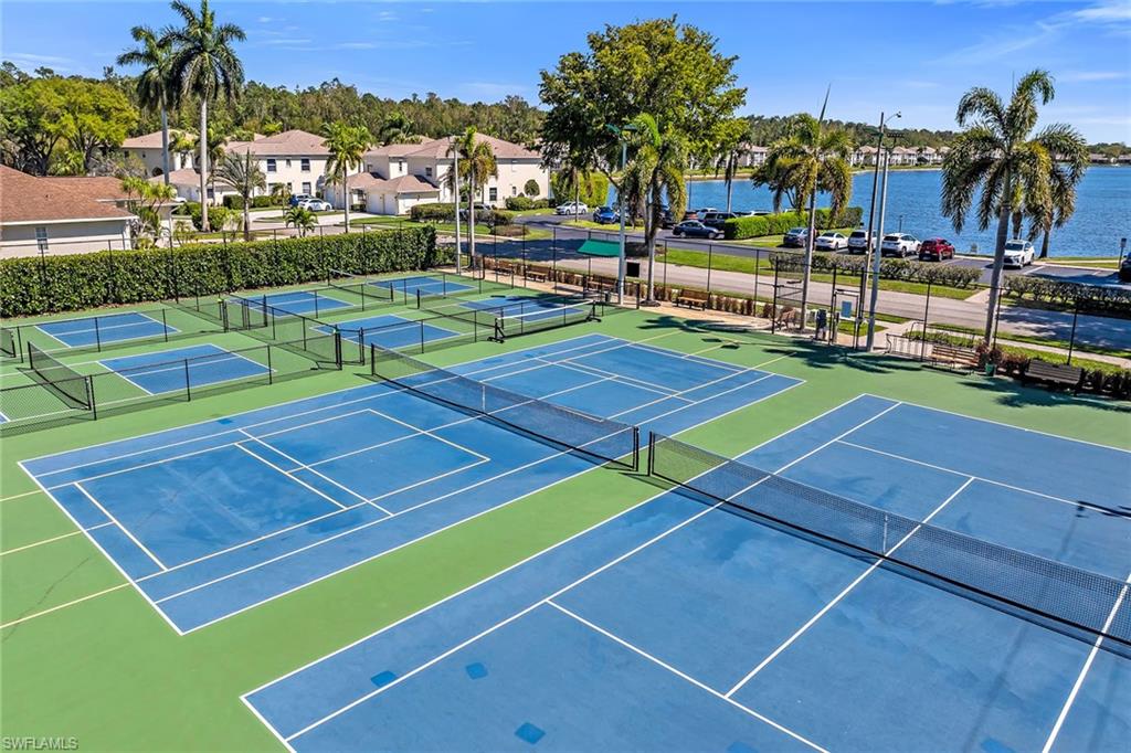 1747 Reuven Circle, Unit 4 Naples, FL 34112 - Photo 42 of 46 a view of a tennis ground with large trees