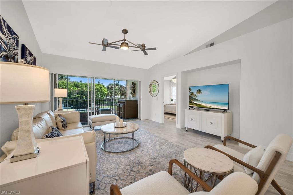 1747 Reuven Circle, Unit 4 Naples, FL 34112 - Photo 6 of 46 a living room with furniture and a large window