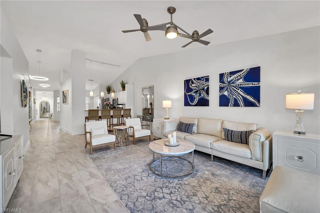 1747 Reuven Circle, Unit 4 Naples, FL 34112 - Photo 8 of 46 a living room with furniture and a ceiling fan