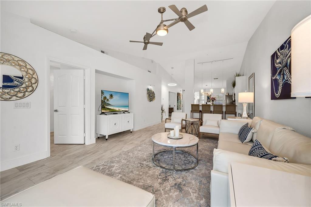 1747 Reuven Circle, Unit 4 Naples, FL 34112 - Photo 9 of 46 a living room with furniture and wooden floor