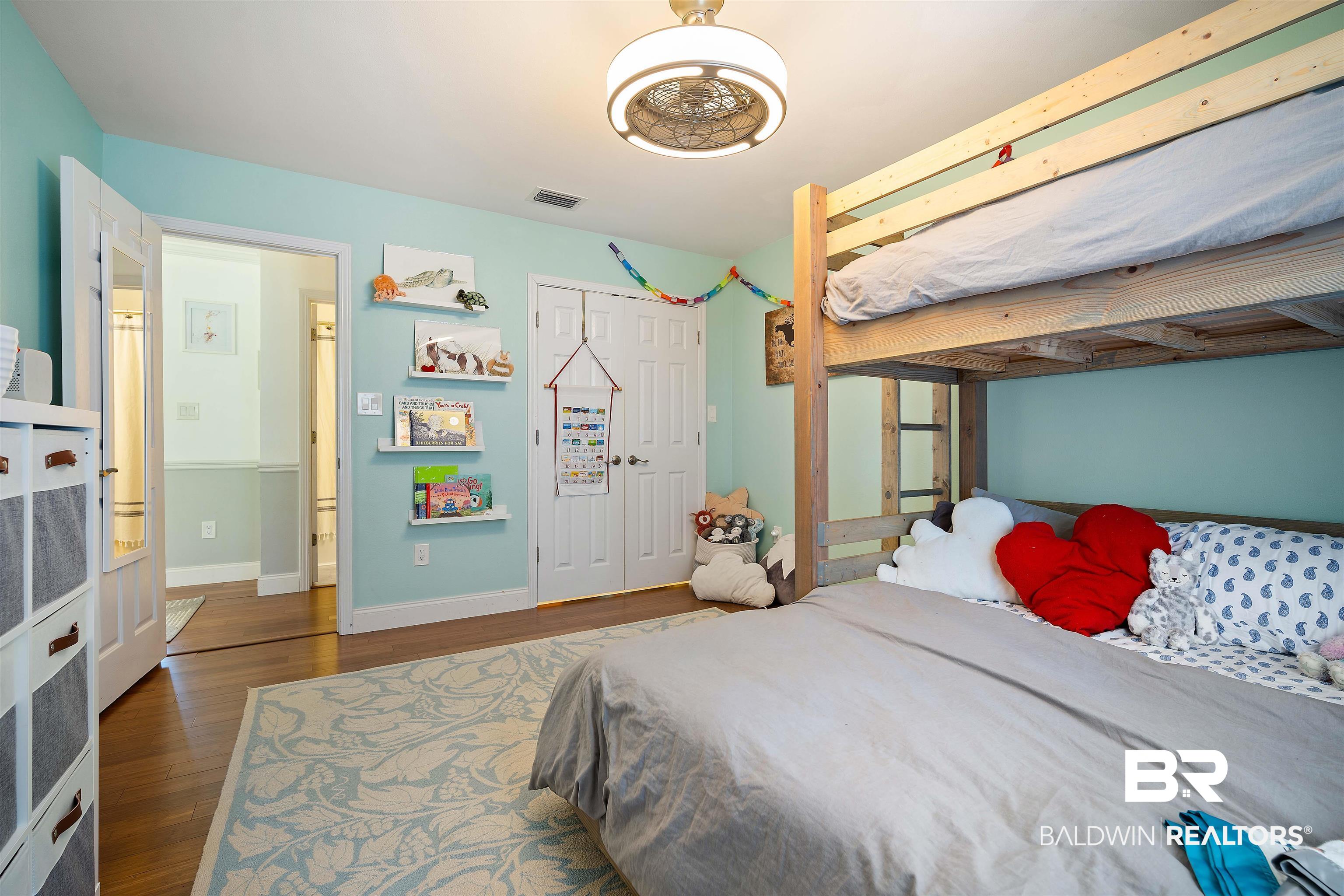 808 Michigan Avenue Fairhope, AL 36532 - Photo 21 of 33 Bedroom featuring beamed ceiling, a closet, and dark hardwood / wood-style floors