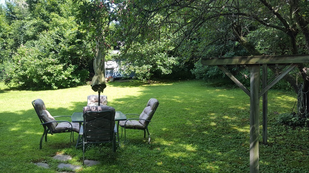 7 Pompano Road Worcester, MA 01605 - Photo 26 of 29 a view of backyard with table and chairs and a large tree