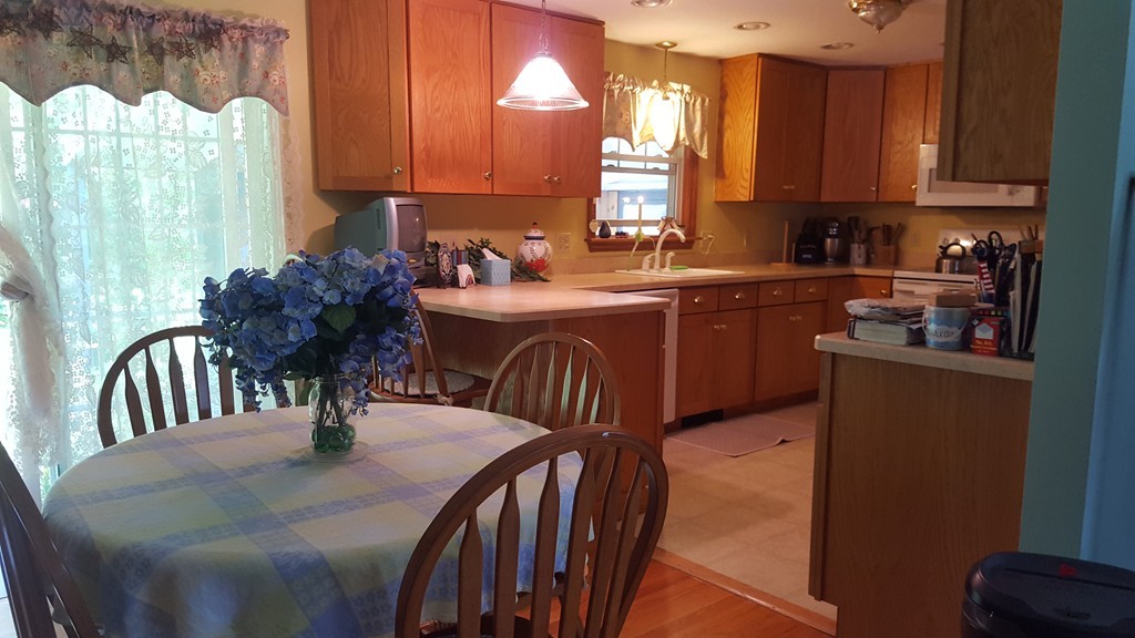 7 Pompano Road Worcester, MA 01605 - Photo 5 of 29 a kitchen with stainless steel appliances granite countertop a sink a stove a dining table and chairs
